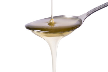 honey in a spoon on white background