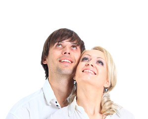 Couple having embraced look afar on a white