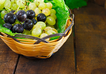 Basket of grapes on rustic wooden table