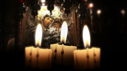 Candle in the night, close up, inside church, loop