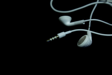 Earphones on a black background