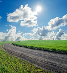 summer landscape with rural road and sky with sun