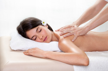 Fototapeta na wymiar Beautiful brunette woman getting a back massage