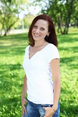 Fototapeta premium Young woman in summer park