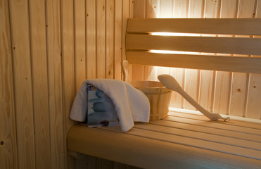 wooden sauna bucket and towel
