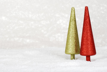 two glitter christmas trees in snow