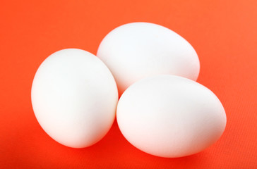 Eggs isolated on red background