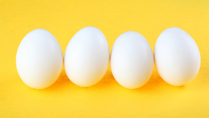 Eggs isolated on yellow background
