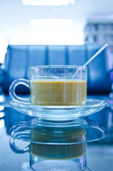 hot coffee in glass cup with plate