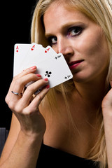 Attractive blond woman with 4 aces