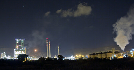 Petrochemical refinery at night with full moon light