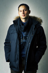 Obraz premium Sexy man in black fur hood winter jacket