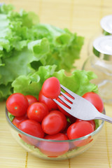 Tomato  cherry on a plug and a bowl with tomatoes