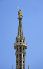 Fototapeta na wymiar Golden Madonna at the top of Milan cathedral