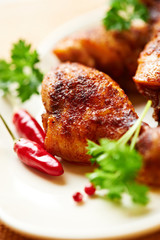 Closeup of roasted chicken legs on a plate