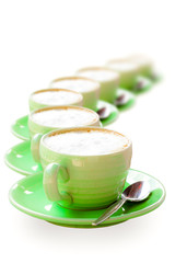 Green coffee cup placed in a row