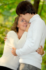 Embracing loving couple in the park