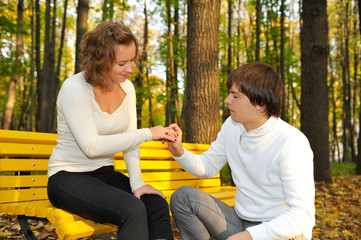 Boyfriend proposing marriage to girlfriend on the park