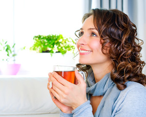 Beautiful Young Woman drinking hot tea