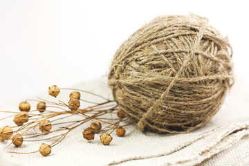 Hank of coarse linen thread with boxes lie on the tissue