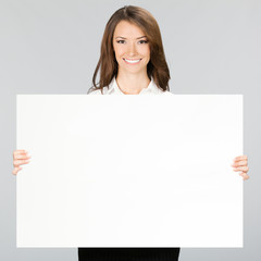 Businesswoman showing signboard, over grey