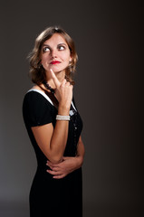 Naklejka premium Thoughtful retro woman in black dress