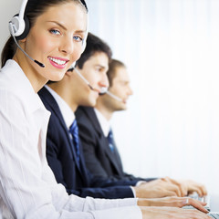 Three support phone operators at workplace