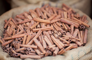 Big bag with cinnamon sticks at indian market