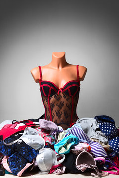 Mannequin in sexy lingerie, pile of bra