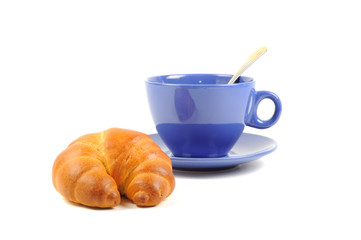 Blue cup with tea and croissant