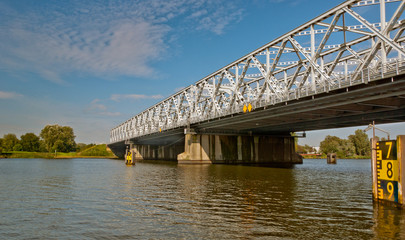 An old truss bridge over a Dutch river