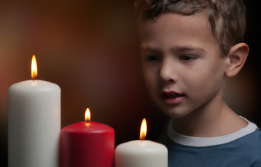 Kid watching candles