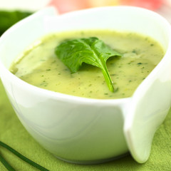 Spinach cream soup with fresh spinach leaf on top