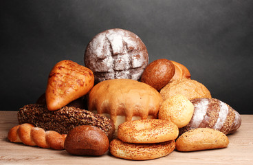 delicious bread on wooden table on gray background