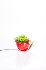 Fresh tomato and salad canape on a fork