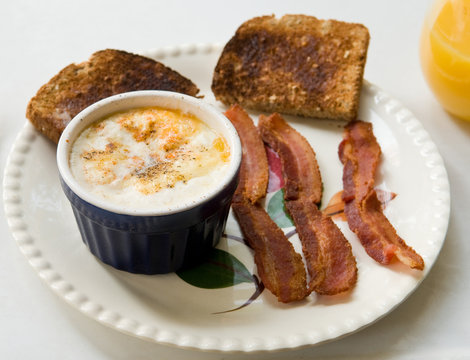 Shirred Eggs In Ramekin With Toast And Bacon