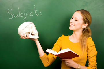 Female student holding skull and book