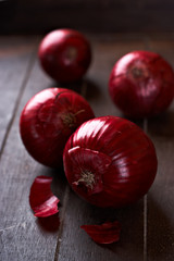 Red onions on wooden background