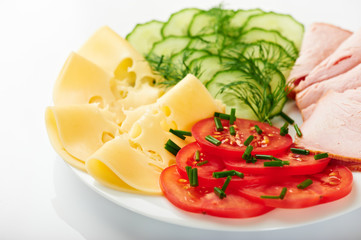 Plate of cold cuts, cheese  and fresh vegetables for breakfast