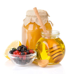 glass jar full of honey and berry