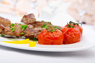 Kebab and tomatoes in the plate
