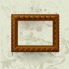 Gilded frame on grunge wall