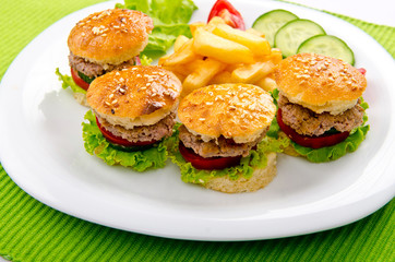 Burgers with french fries in plate