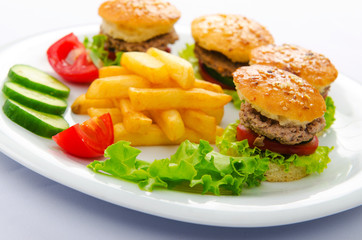 Plate with tasty mini burgers