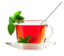 Cup of fragrant tea with fresh leaves of green tea isolated