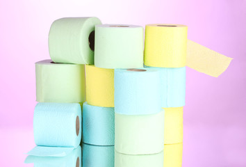 bright rolls of toilet paper on pink background