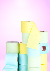 bright rolls of toilet paper on pink background