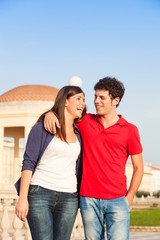 Happy Young Couple Walking Embraced