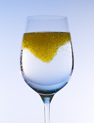 Olive oil stirred into wine glass