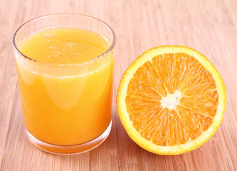 Glass of Orange juice and a half of an orange